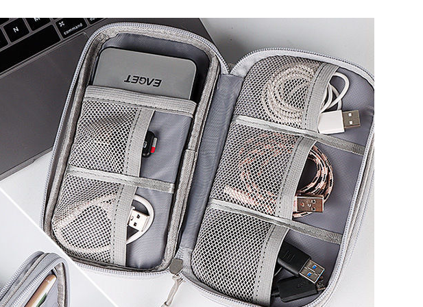 Close-up of tech organizer mesh compartments holding accessories.