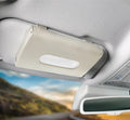 Beige car visor tissue holder shown closed with tissue opening