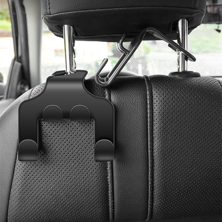 Black car headrest hook installed behind a seat holding a clothes hanger