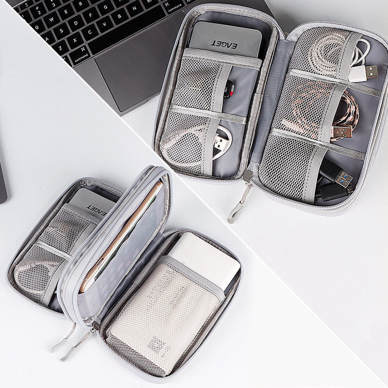 Open tech organizer pouch showing mesh compartments and storage examples.