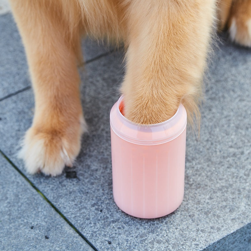 Dog paw being placed inside a portable paw cleaner cup.