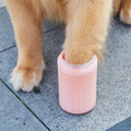 Dog paw being placed inside a portable paw cleaner cup.