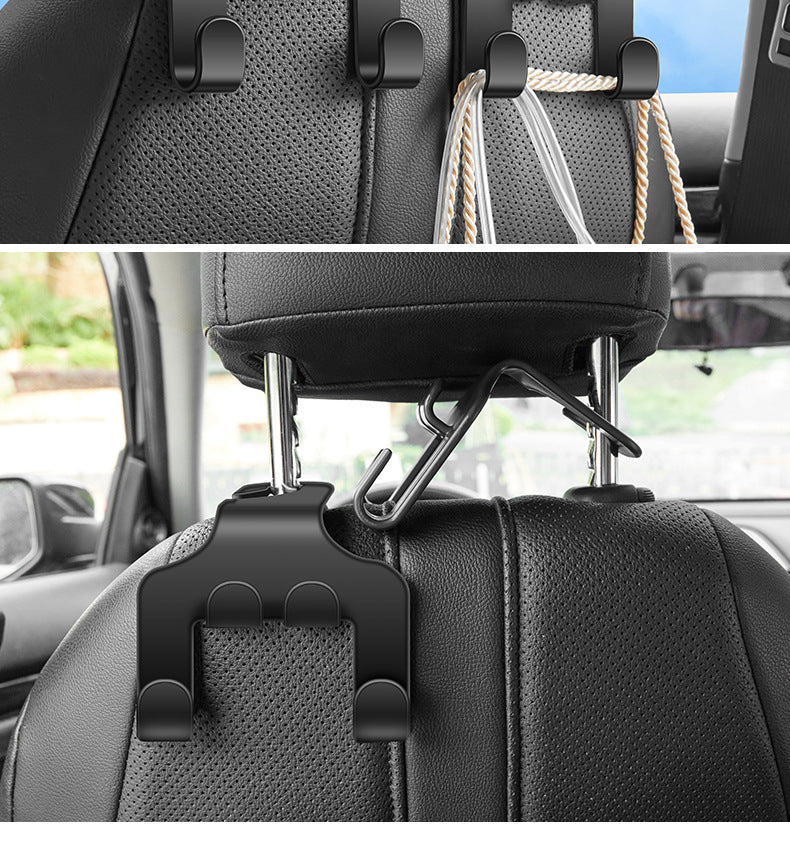 Black headrest hook holding a clothes hanger behind a vehicle seat
