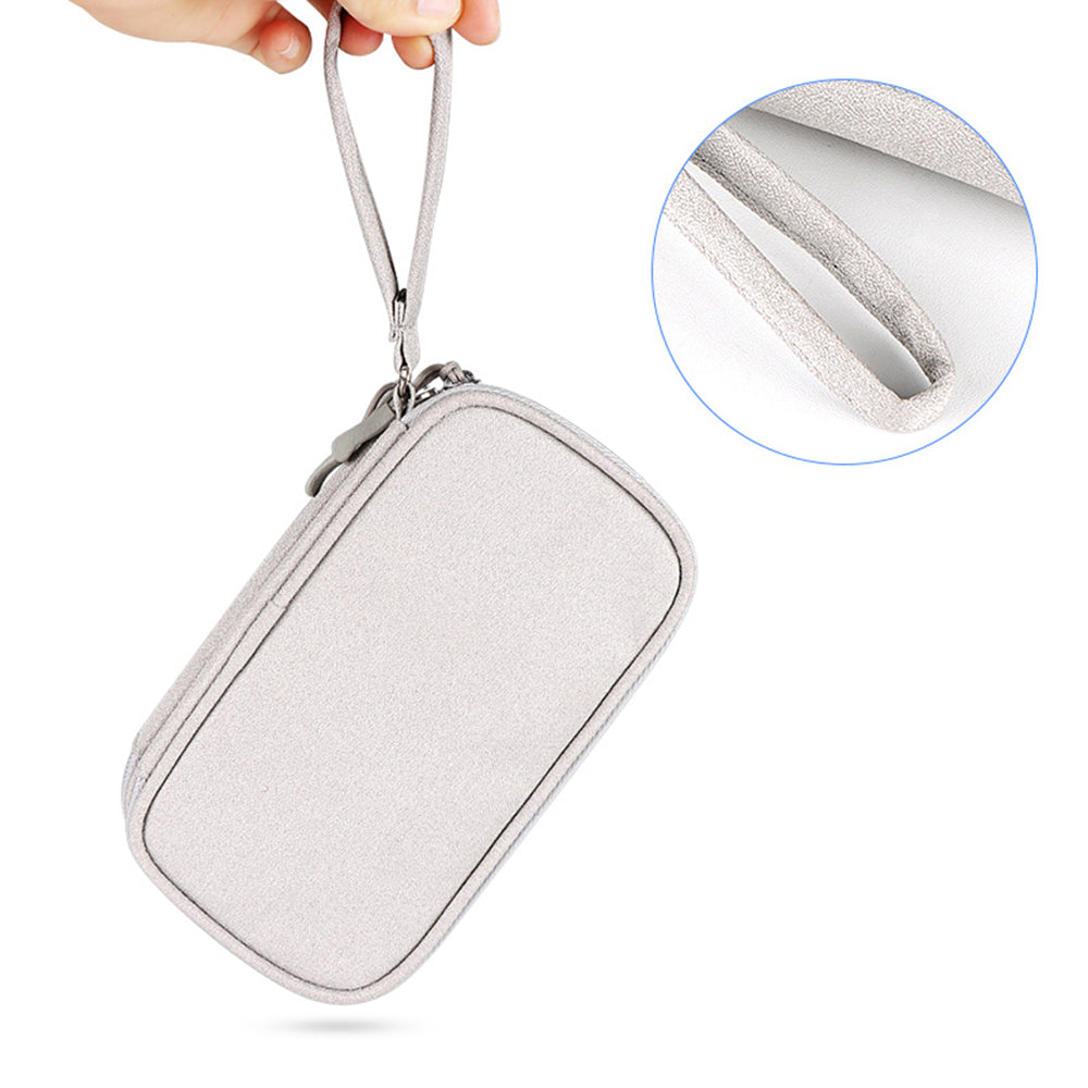 Tech organizer pouch hanging from its carrying strap.