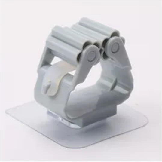 Gray cleaning-tool holder with an adhesive mounting pad.