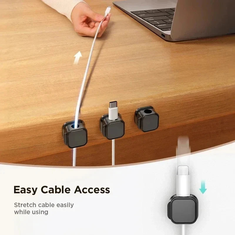 Black magnetic cable organizer clips holding charging cables.