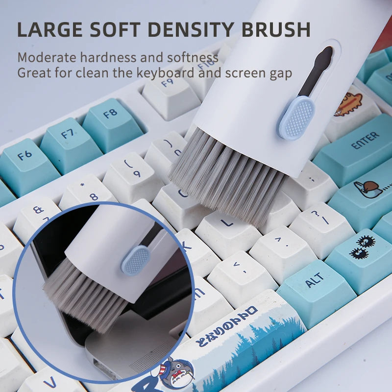 Retractable cleaning brush used between keyboard keys