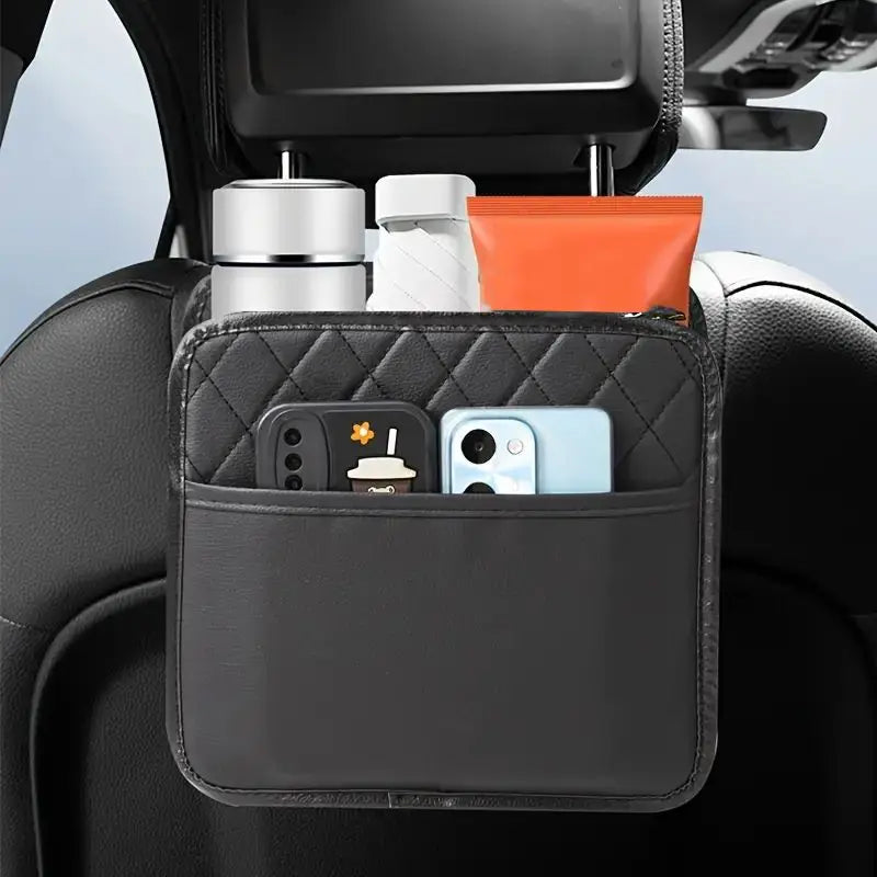 Black quilted car seat back organizer filled with two phones, a tumbler, and a bottle, hanging from a headrest