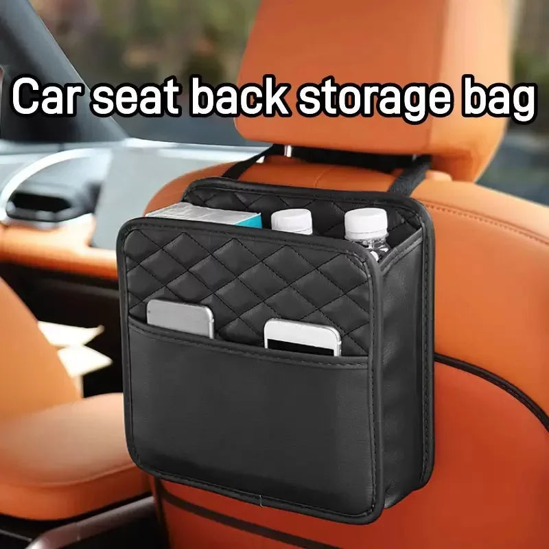 Black quilted car seat back organizer hanging from a headrest, holding water bottles, phones, and snacks in a tan leather interior