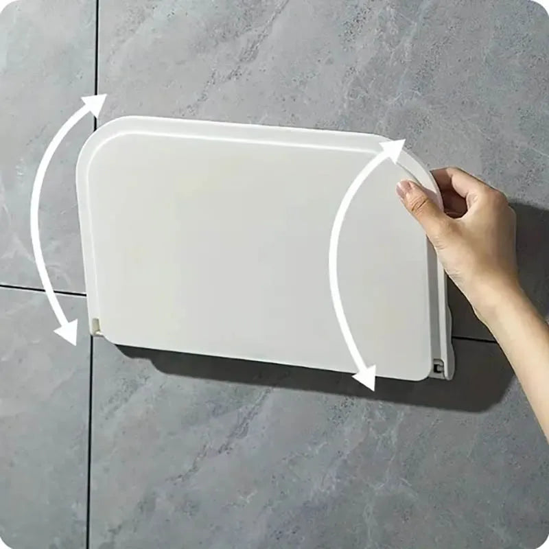Foldable wall-mounted shelf shown opening and folding against the wall