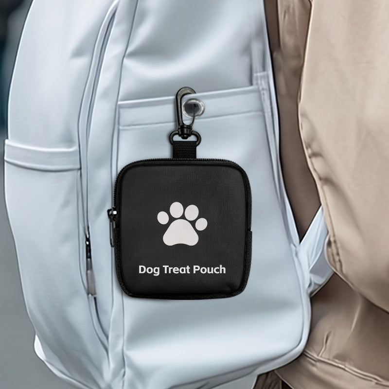 Black dog training treat pouch clipped to a backpack.